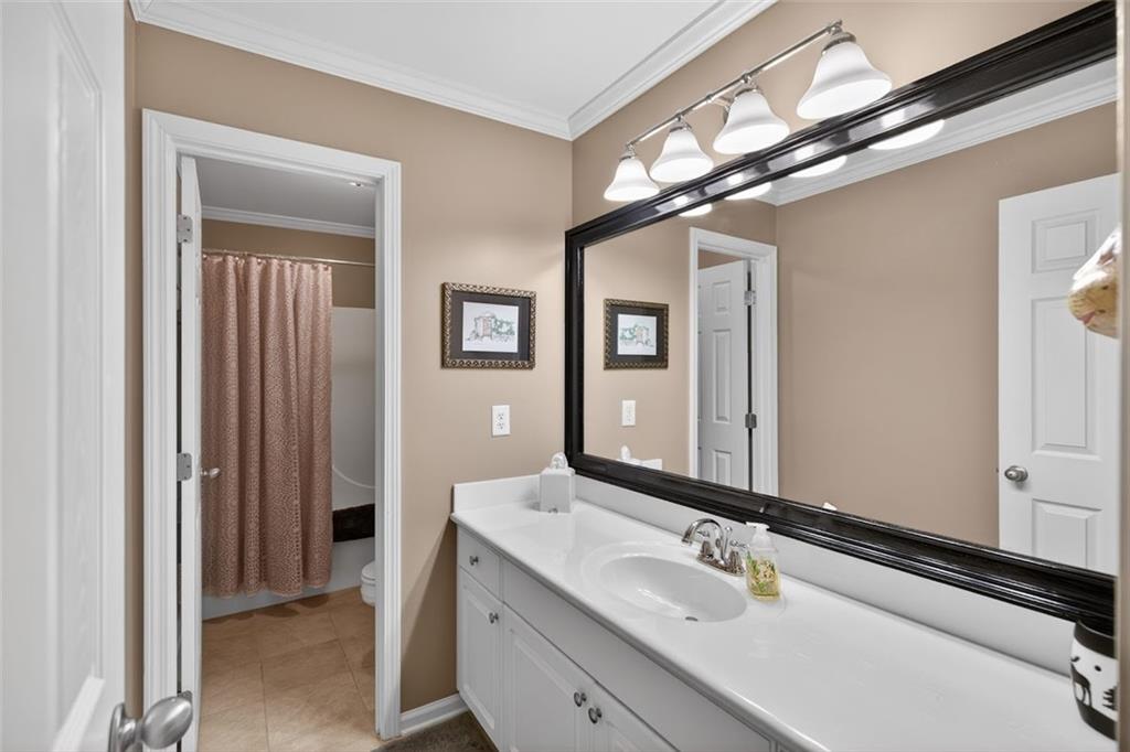 129 Dorchester Way Villa Rica, GA 30180 - Photo 31 of 65 a bathroom with a sink a vanity and a mirror