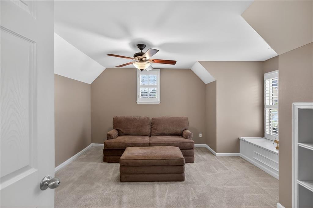 129 Dorchester Way Villa Rica, GA 30180 - Photo 32 of 65 a living room with furniture and a ceiling fan