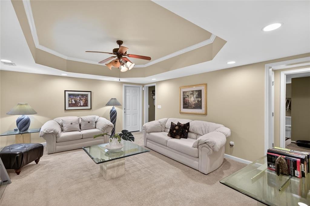 129 Dorchester Way Villa Rica, GA 30180 - Photo 36 of 65 a living room with furniture and a flat screen tv