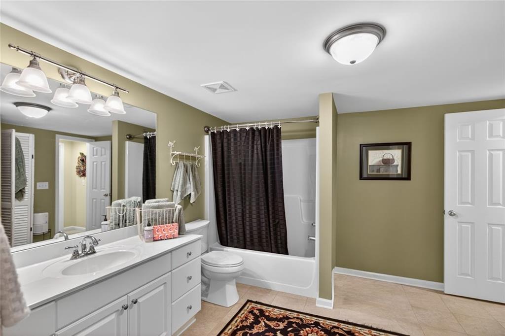 129 Dorchester Way Villa Rica, GA 30180 - Photo 38 of 65 a bathroom with a sink a toilet and shower