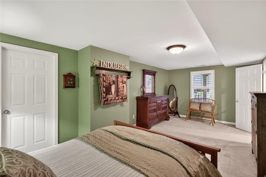 129 Dorchester Way Villa Rica, GA 30180 - Photo 40 of 65 a bedroom with a bed and furniture