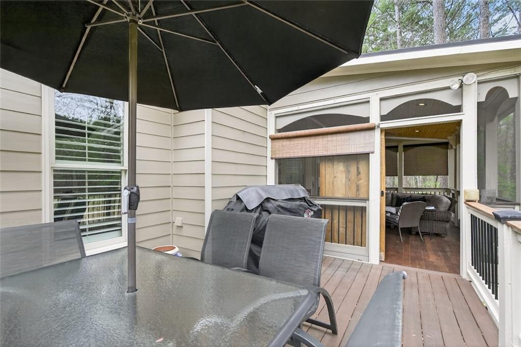 129 Dorchester Way Villa Rica, GA 30180 - Photo 46 of 65 a view of a patio with table and chairs under an umbrella