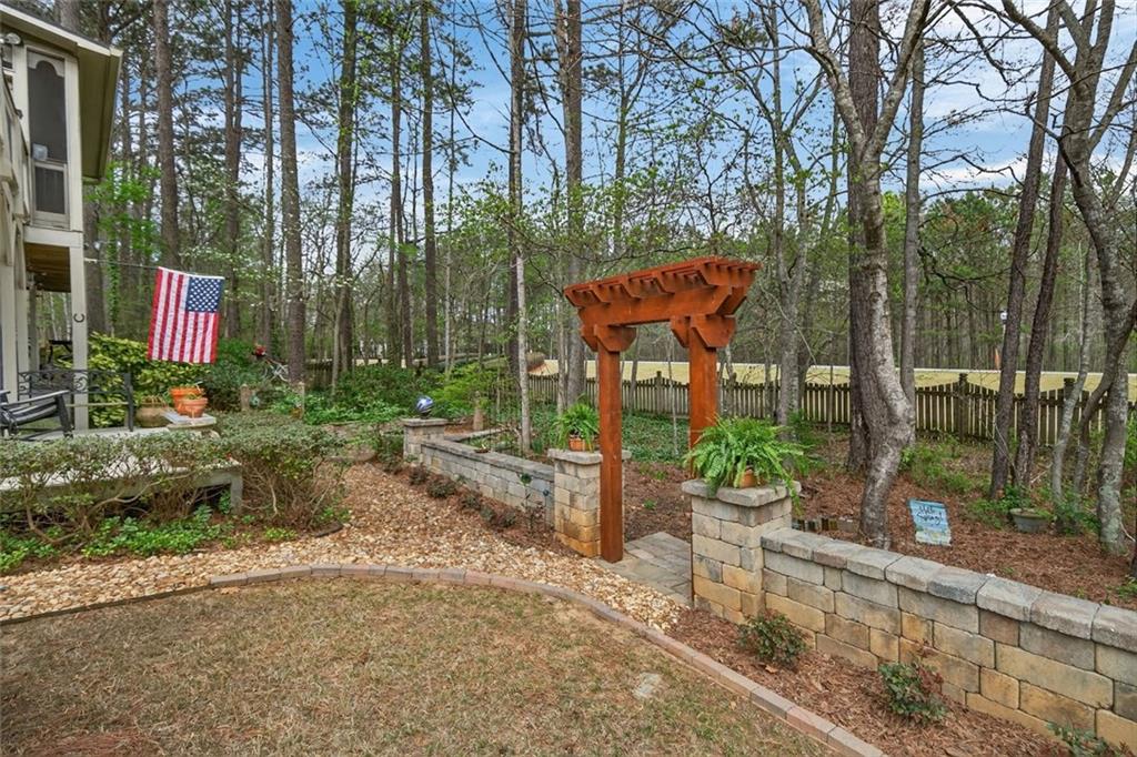129 Dorchester Way Villa Rica, GA 30180 - Photo 51 of 65 a wooden bench sitting in front of a building