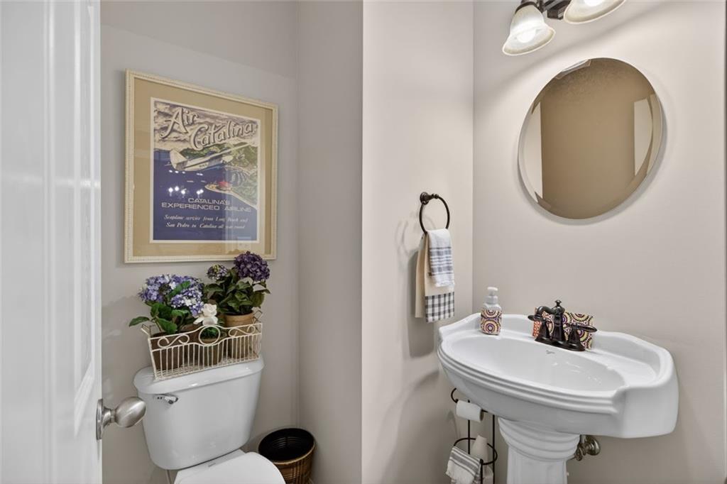 129 Dorchester Way Villa Rica, GA 30180 - Photo 7 of 65 a bathroom with a toilet sink and mirror