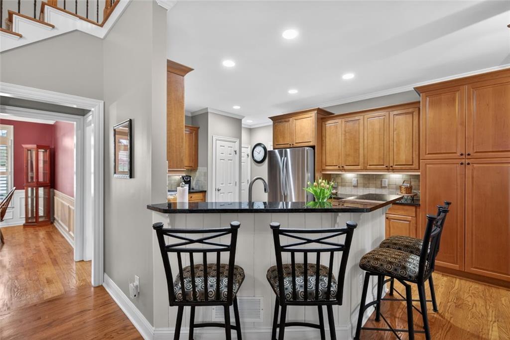129 Dorchester Way Villa Rica, GA 30180 - Photo 9 of 65 a kitchen with stainless steel appliances granite countertop a dining table chairs and granite counter tops