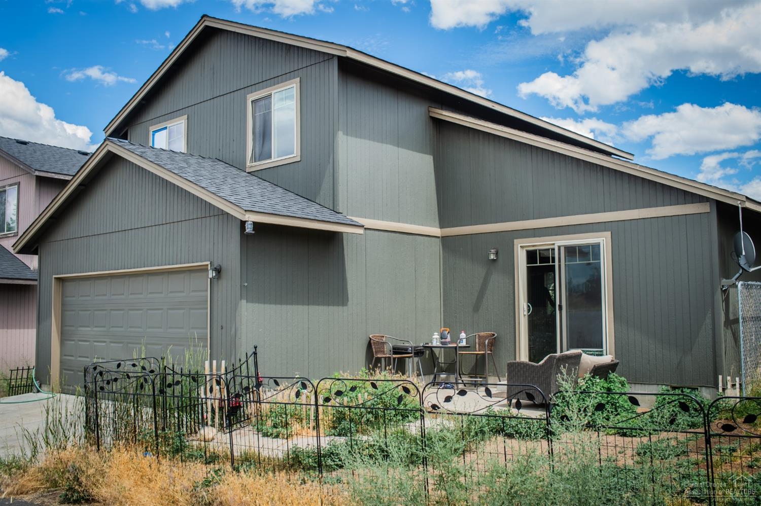 63287 Vogt Road Bend, OR 97701 - Photo 16 of 16 a front view of a house with garden