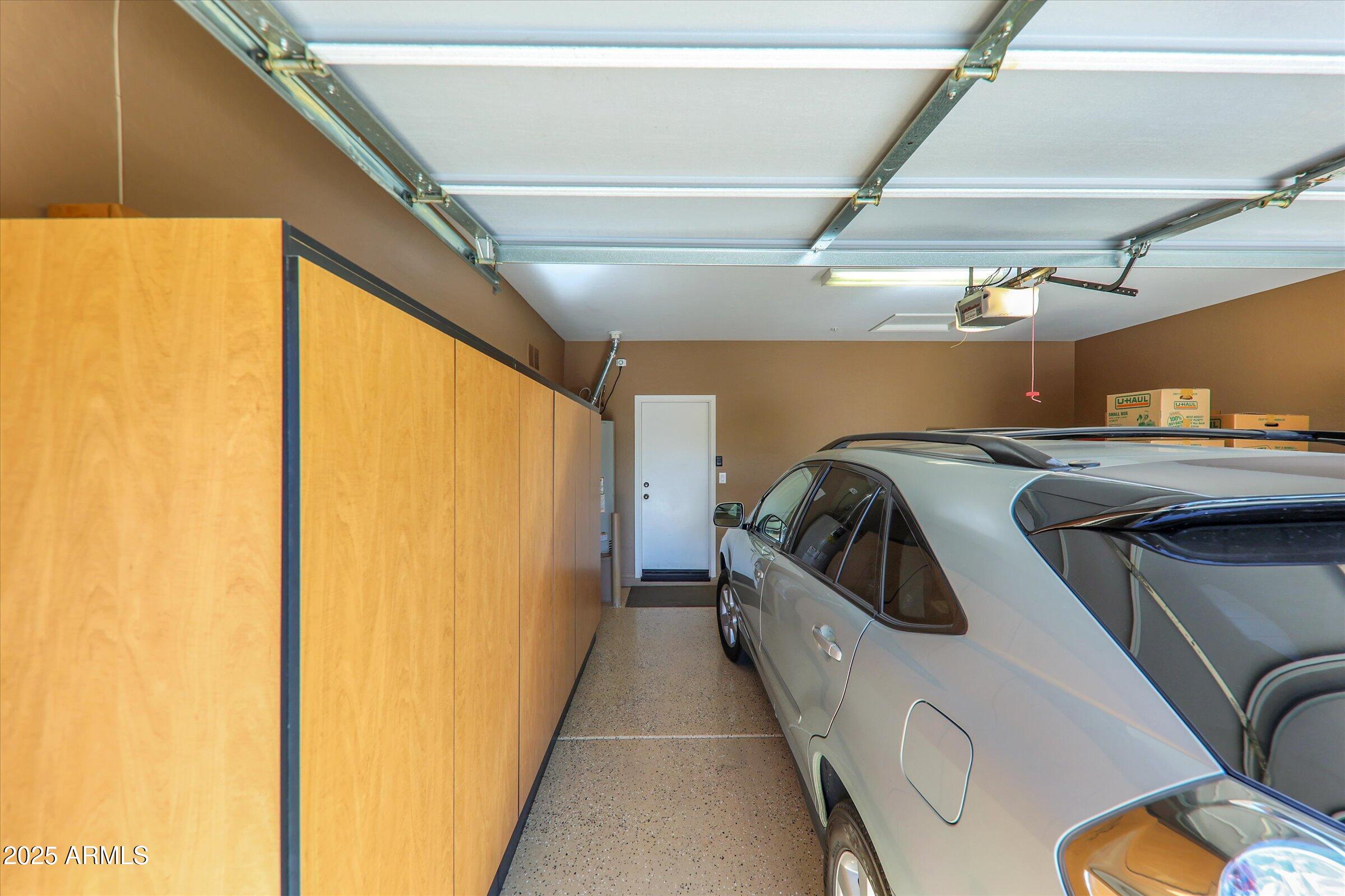 41532 North Clear Crossing Road Anthem, AZ 85086 - Photo 37 of 57 Garage has epoxy flooring and cabinet
