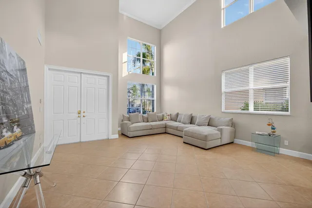 a dining room with furniture a chandelier and window