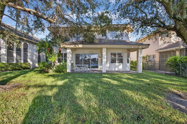 a view of a backyard patio and swimming pool