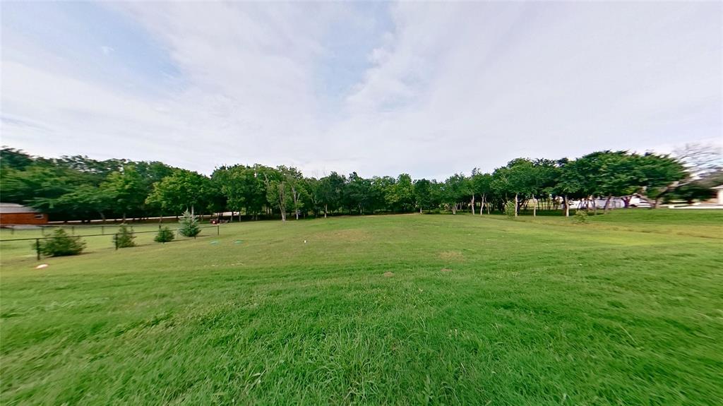 3248 North Cardinal Road Azle, TX 76020 - Photo 29 of 29 Expansive grassy terrain featuring mature trees along the perimeter and a clear sky overhead