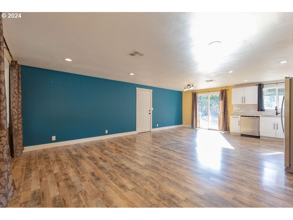 2102 Delta Street Eugene, OR 97404 - Photo 11 of 35 a view of an empty room with wooden floor and a window
