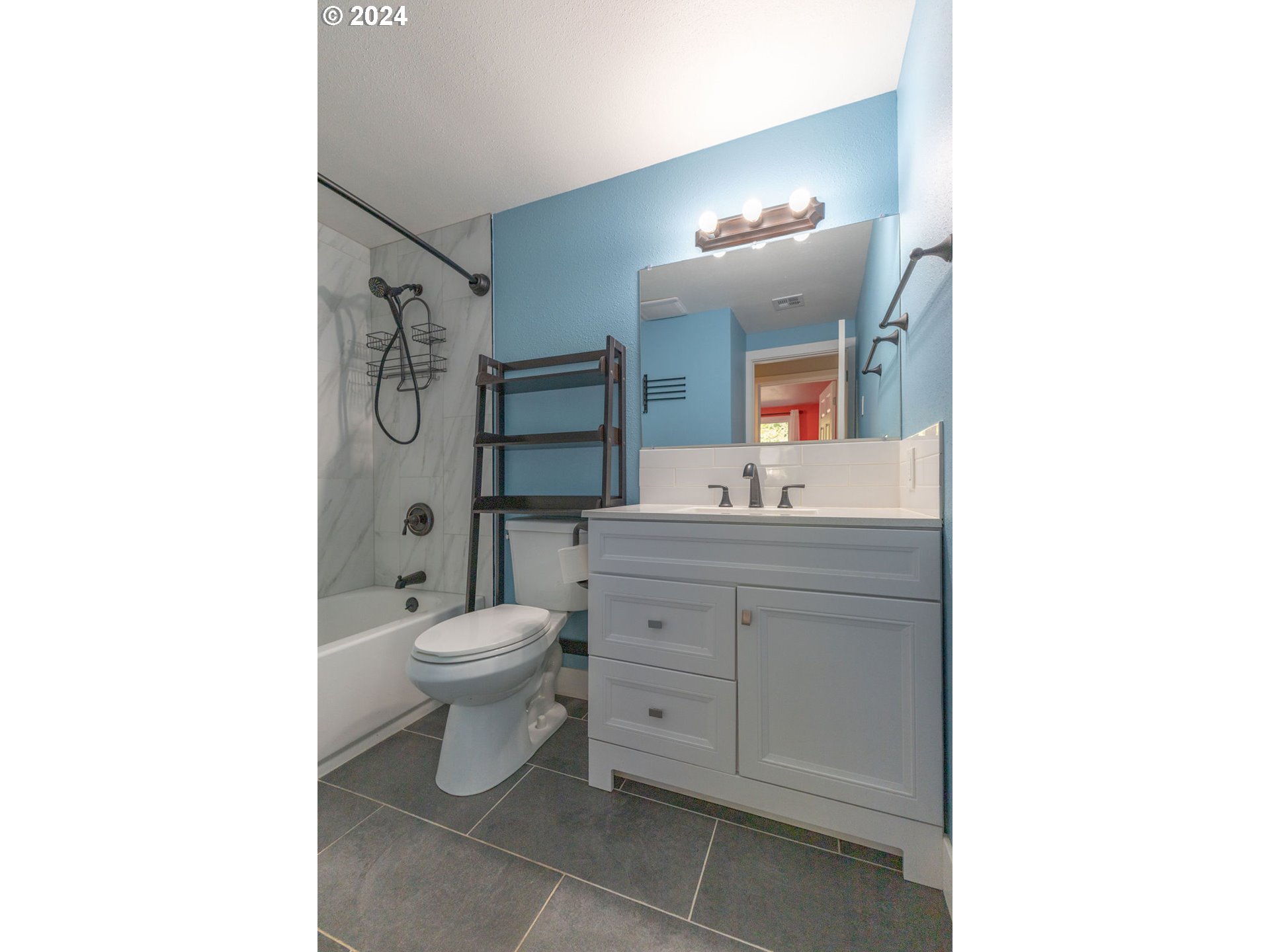 2102 Delta Street Eugene, OR 97404 - Photo 13 of 35 a bathroom with a toilet sink vanity and mirror