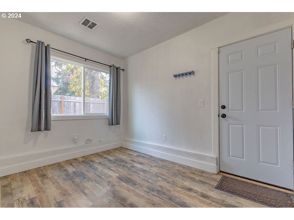 2102 Delta Street Eugene, OR 97404 - Photo 26 of 35 an empty room with wooden floor and windows