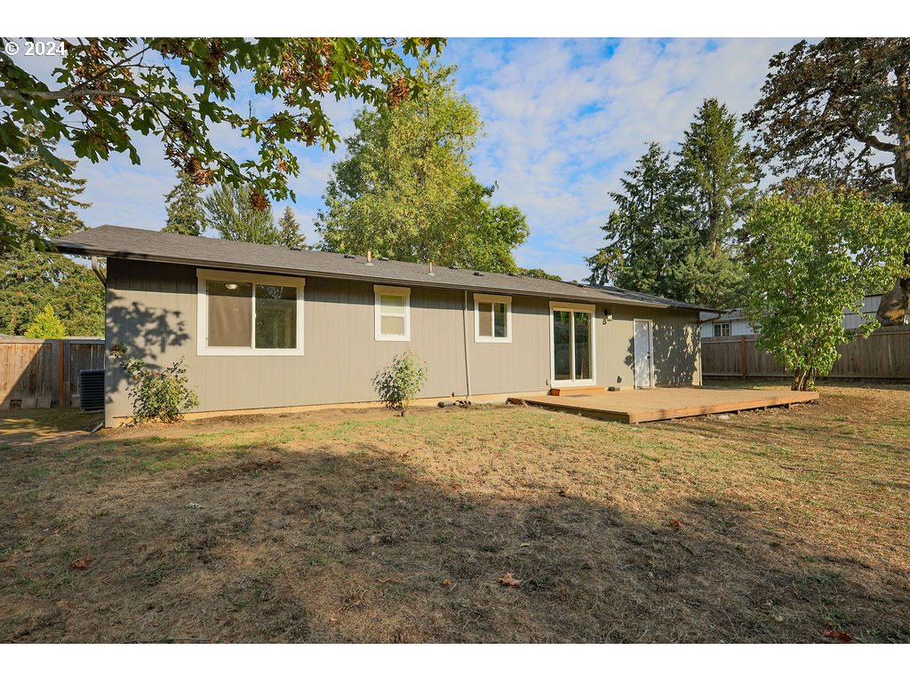 2102 Delta Street Eugene, OR 97404 - Photo 28 of 35 a backyard of a house with table and chairs under an umbrella