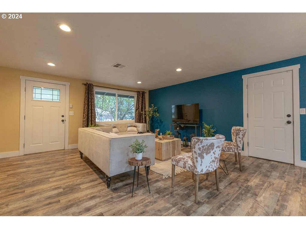 2102 Delta Street Eugene, OR 97404 - Photo 31 of 35 a living room with furniture a flat screen tv and a wooden floor