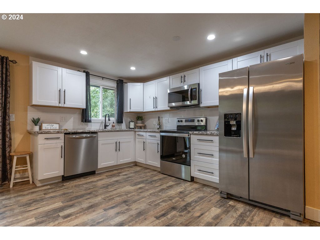 2102 Delta Street Eugene, OR 97404 - Photo 34 of 35 a kitchen with a refrigerator stove and microwave
