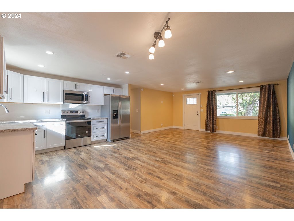 2102 Delta Street Eugene, OR 97404 - Photo 9 of 35 a view of kitchen with sink and wooden floor