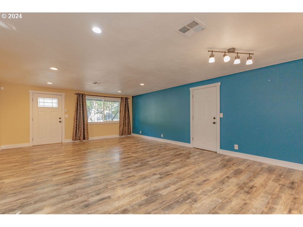 2102 Delta Street Eugene, OR 97404 - Photo 10 of 35 a view of an empty room with window and wooden floor
