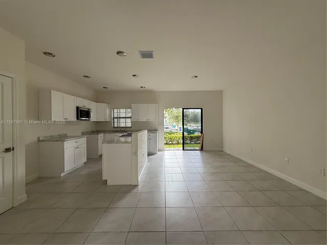a kitchen with a sink a counter top space and appliances