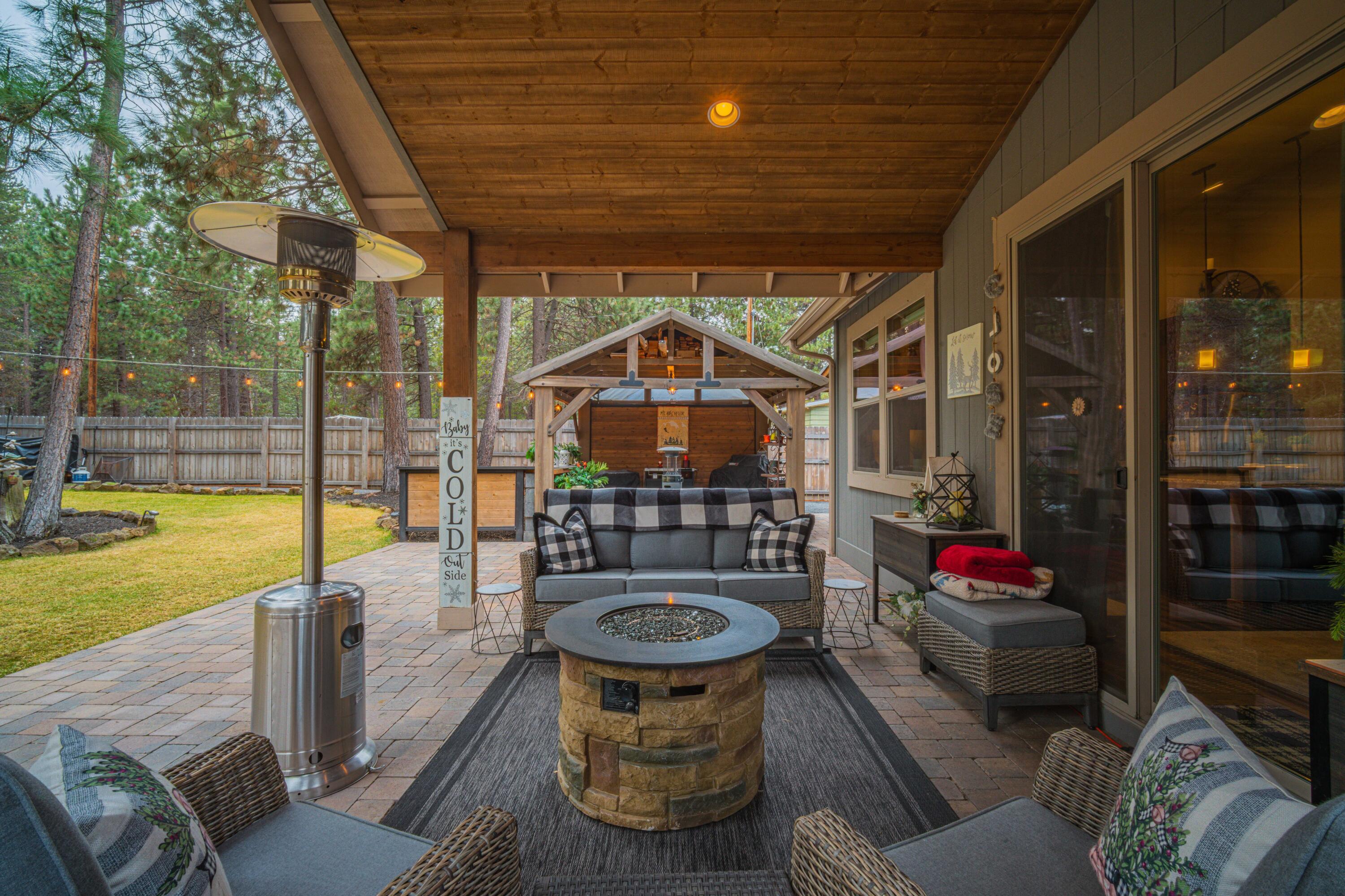 16927 Covina Road Bend, OR 97707 - Photo 28 of 54 Covered patio opening to the outdoor pavilion and entertaining areas, highlighting the seamless indoor outdoor living that makes this property so extraordinary.