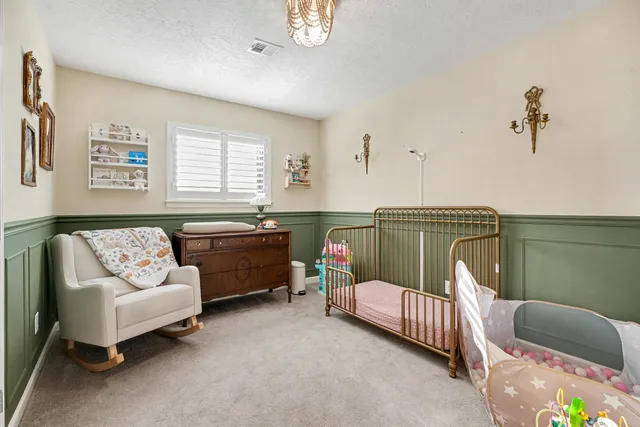 a bedroom with furniture and a window