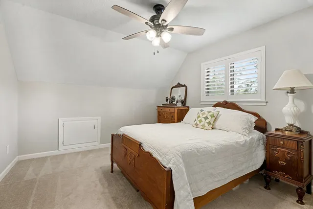 a bedroom with a bed and a ceiling fan