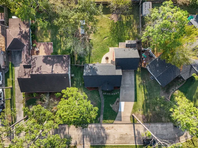an aerial view of a house with garden space and street view