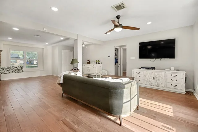 a view of a livingroom with furniture and a flat screen tv