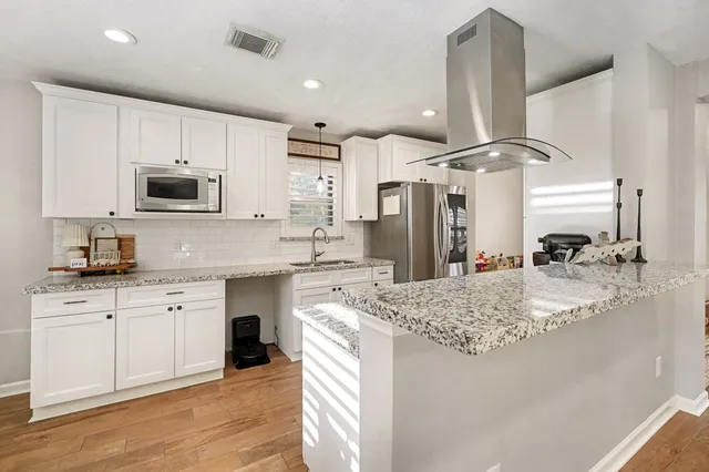 a living room with furniture and kitchen view