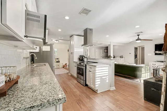 a large kitchen with stainless steel appliances lots of counter top space