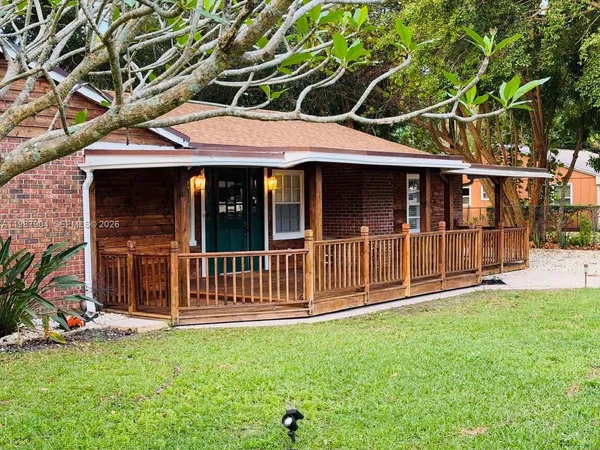 a view of a house with a backyard and a garden