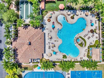a view of a swimming pool with outdoor seating and plants