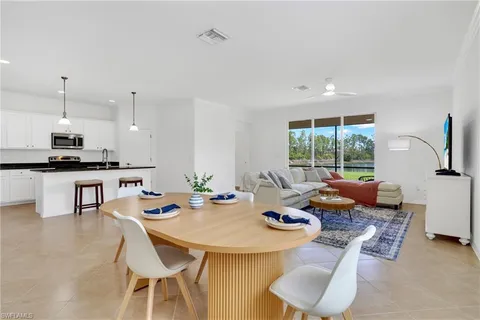a kitchen with granite countertop a sink stainless steel appliances and cabinets