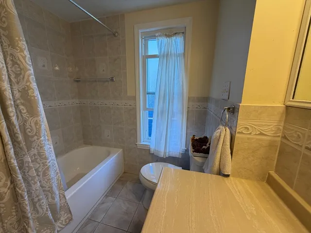 a bathroom with a tub and shower