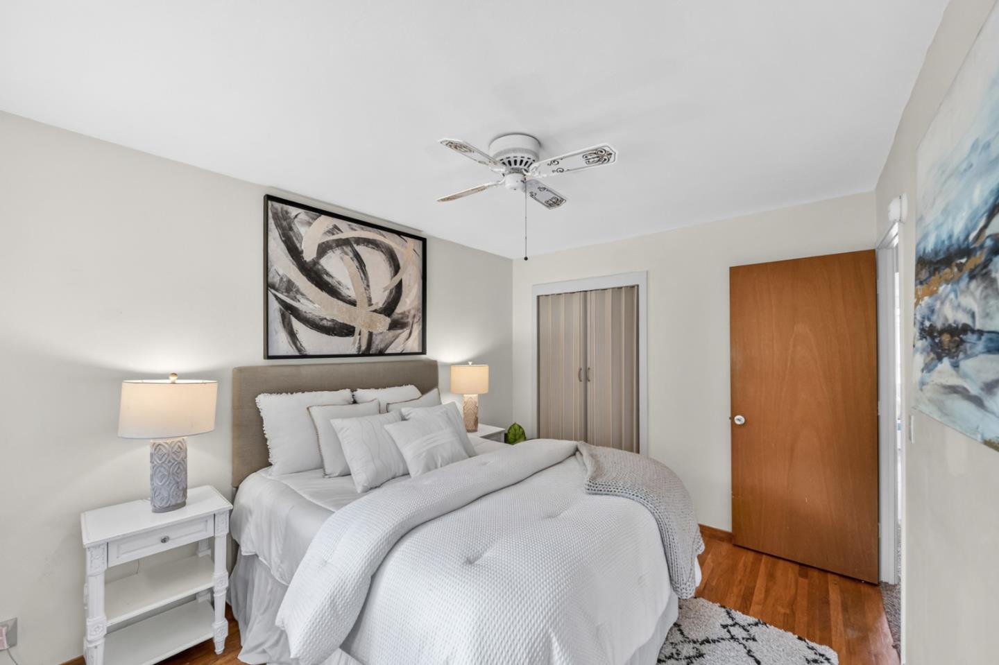 1287 Lerida Way Pacifica, CA 94044 - Photo 32 of 52 a bedroom with a bed and a chandelier
