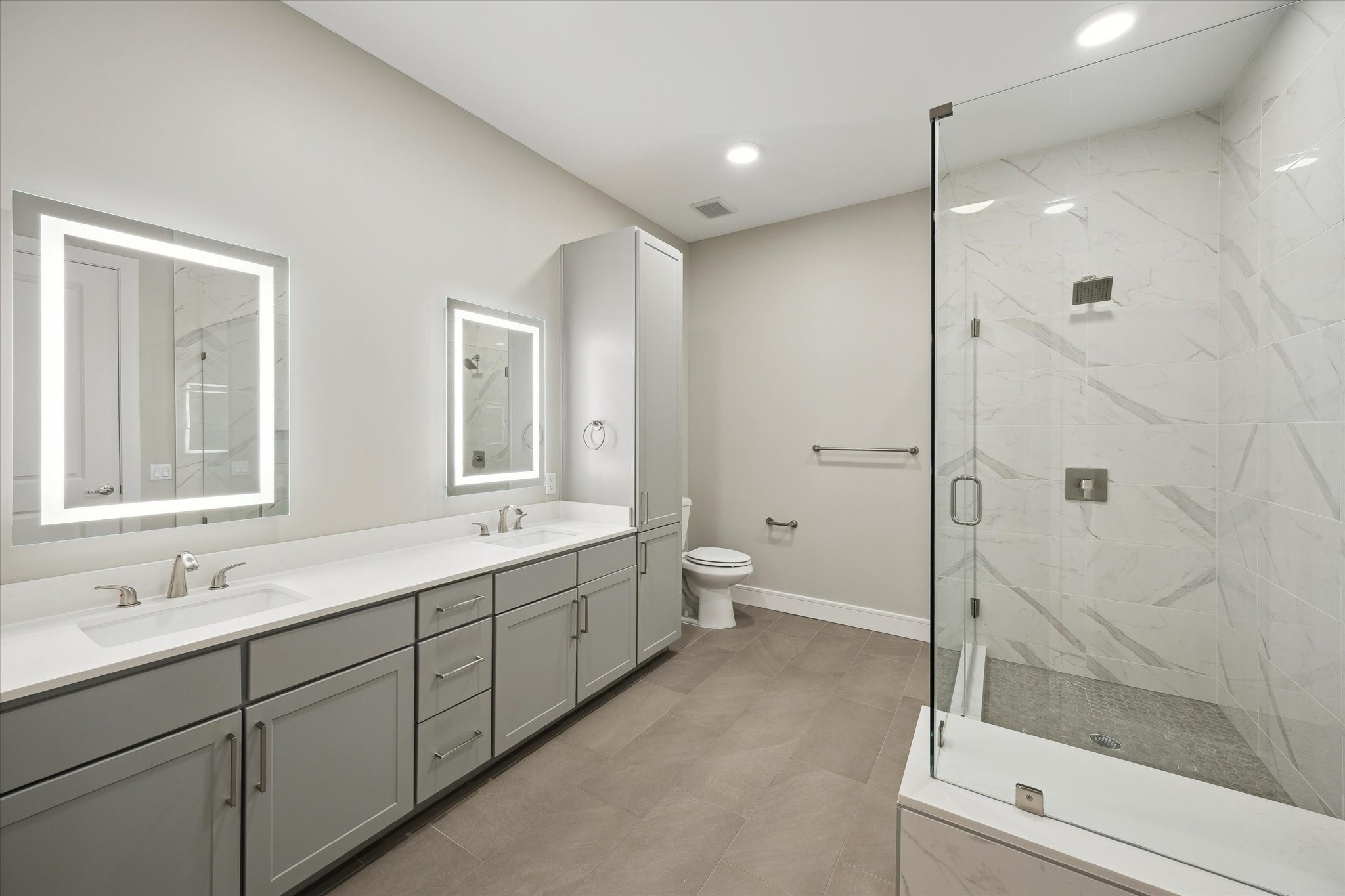 9757 Katy Freeway, Unit 822 Houston, TX 77024 - Photo 12 of 30 a bathroom with a double vanity sink toilet mirror and next to a window