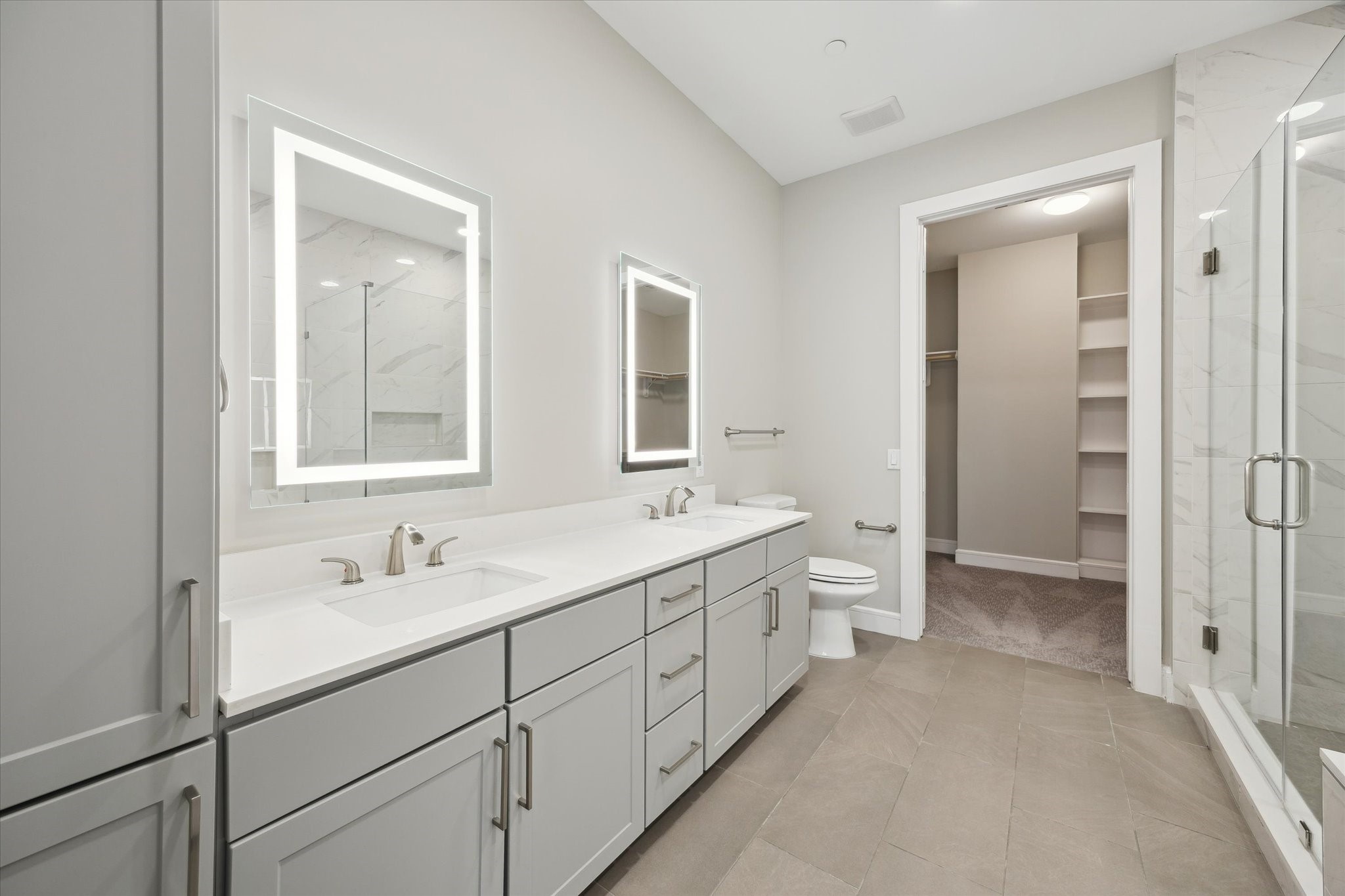 9757 Katy Freeway, Unit 822 Houston, TX 77024 - Photo 15 of 30 a spacious bathroom with a double vanity sink mirror and toilet