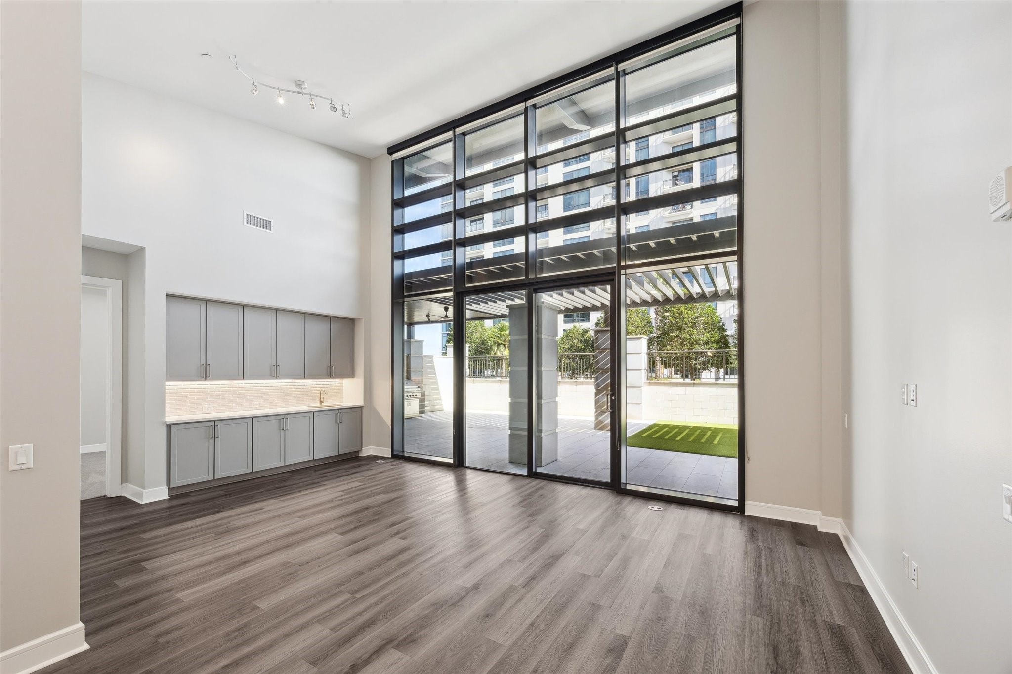 9757 Katy Freeway, Unit 822 Houston, TX 77024 - Photo 2 of 30 a view of an empty room with wooden floor and a window