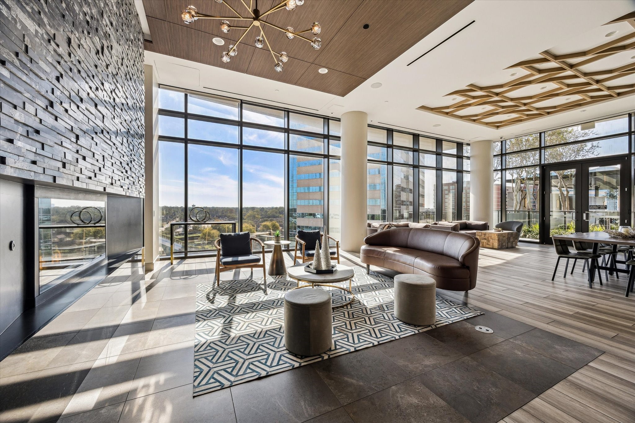 9757 Katy Freeway, Unit 822 Houston, TX 77024 - Photo 25 of 30 a living room with couches and a dining table with garden view