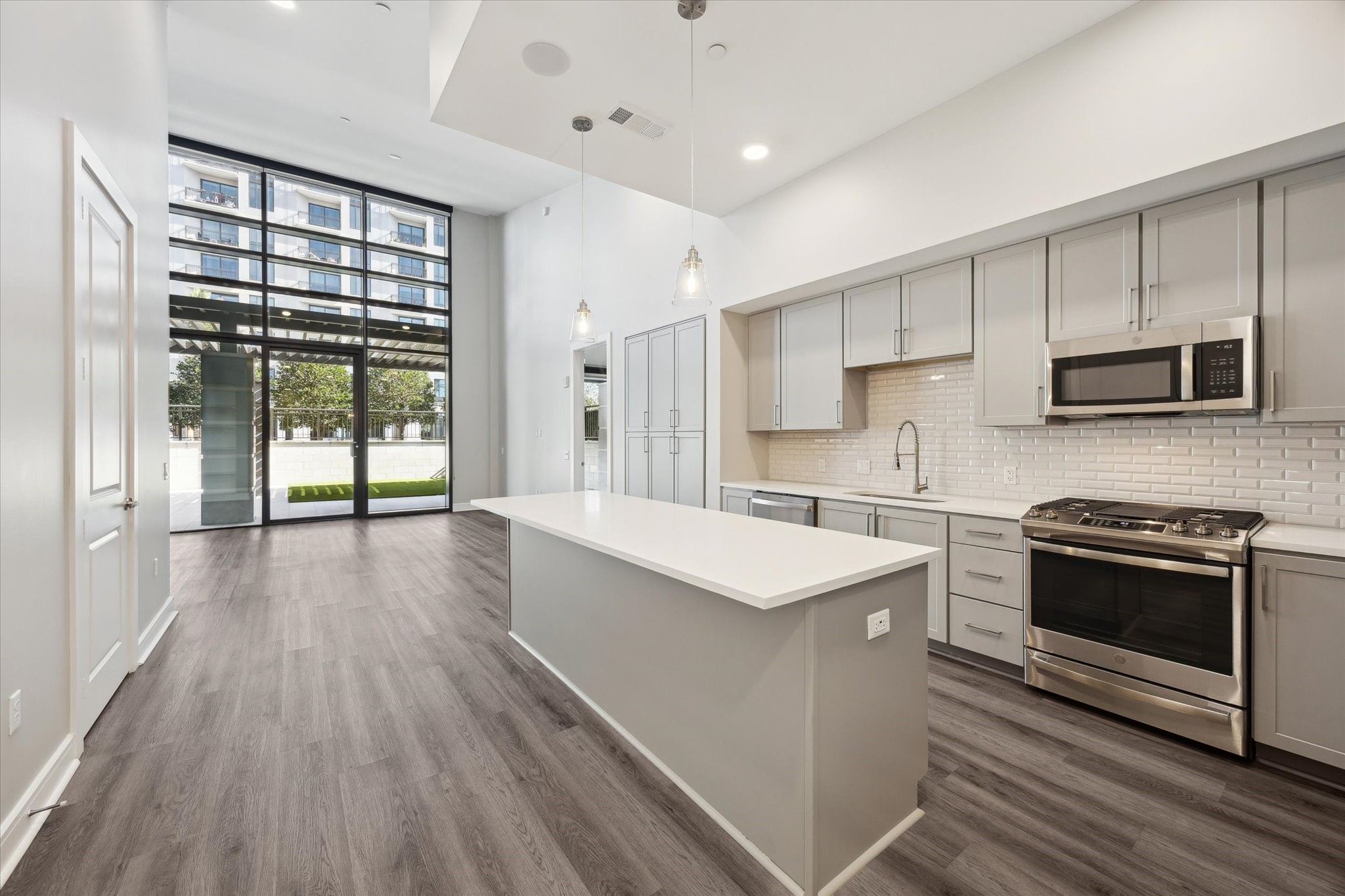 9757 Katy Freeway, Unit 822 Houston, TX 77024 - Photo 7 of 30 a kitchen with stainless steel appliances a stove sink and microwave