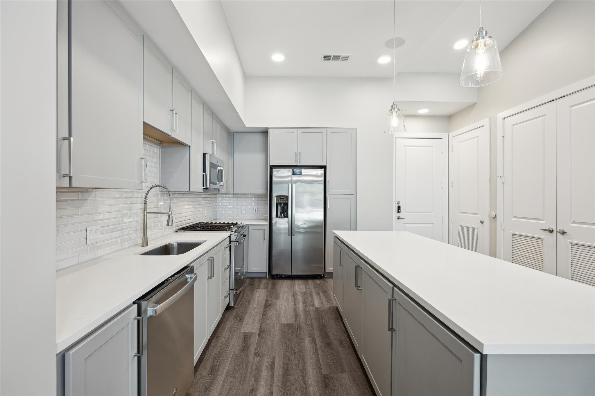 9757 Katy Freeway, Unit 822 Houston, TX 77024 - Photo 8 of 30 a kitchen with a sink a counter top space stainless steel appliances and cabinets