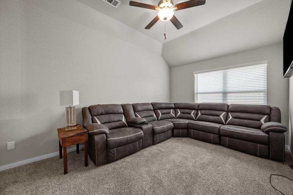 3501 Beutel Road Lorena, TX 76655 - Photo 21 of 33 Living area featuring carpet, lofted ceiling, and a ceiling fan
