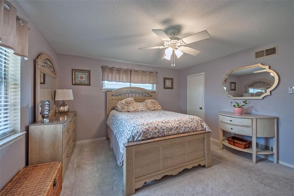 5739 Banting Way Dallas, TX 75227 - Photo 13 of 15 a bedroom with a bed and a chandelier