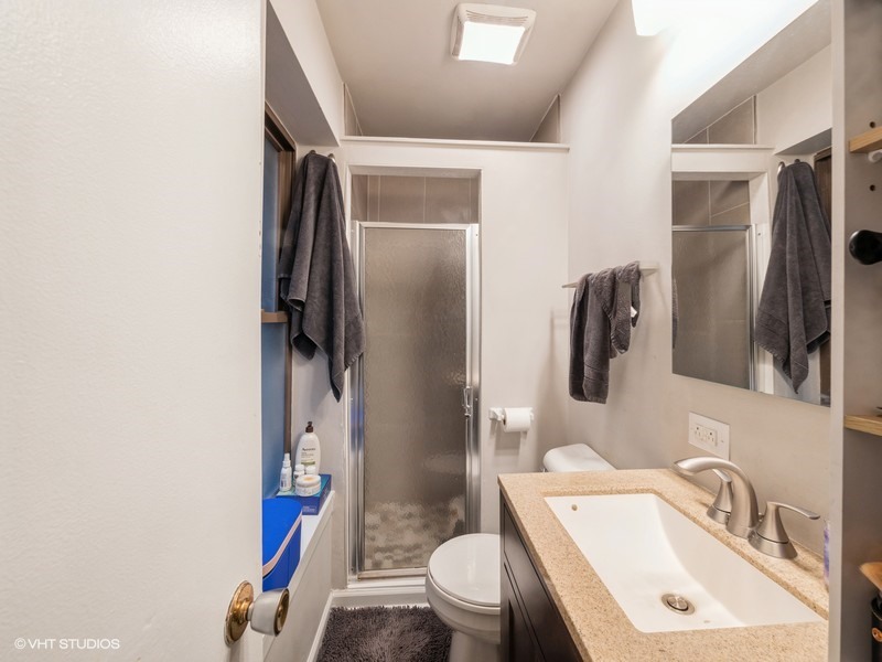 1038 West Byron Street, Unit 2E Chicago, IL 60613 - Photo 11 of 11 a bathroom with a sink toilet and shower