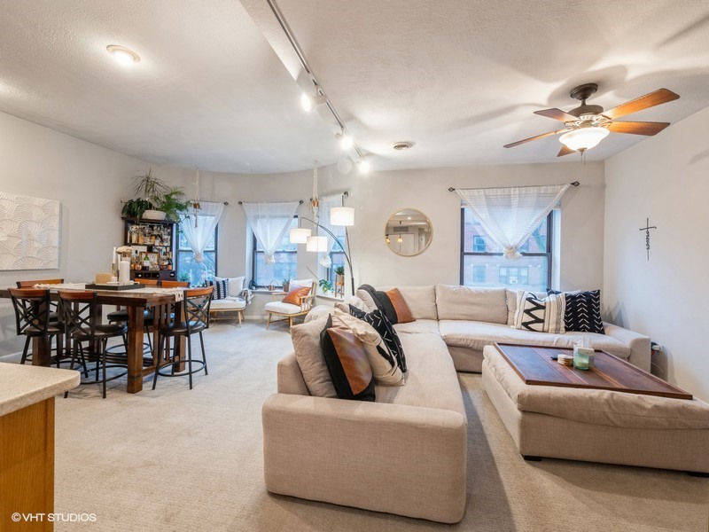 1038 West Byron Street, Unit 2E Chicago, IL 60613 - Photo 2 of 11 a living room with furniture and a chandelier