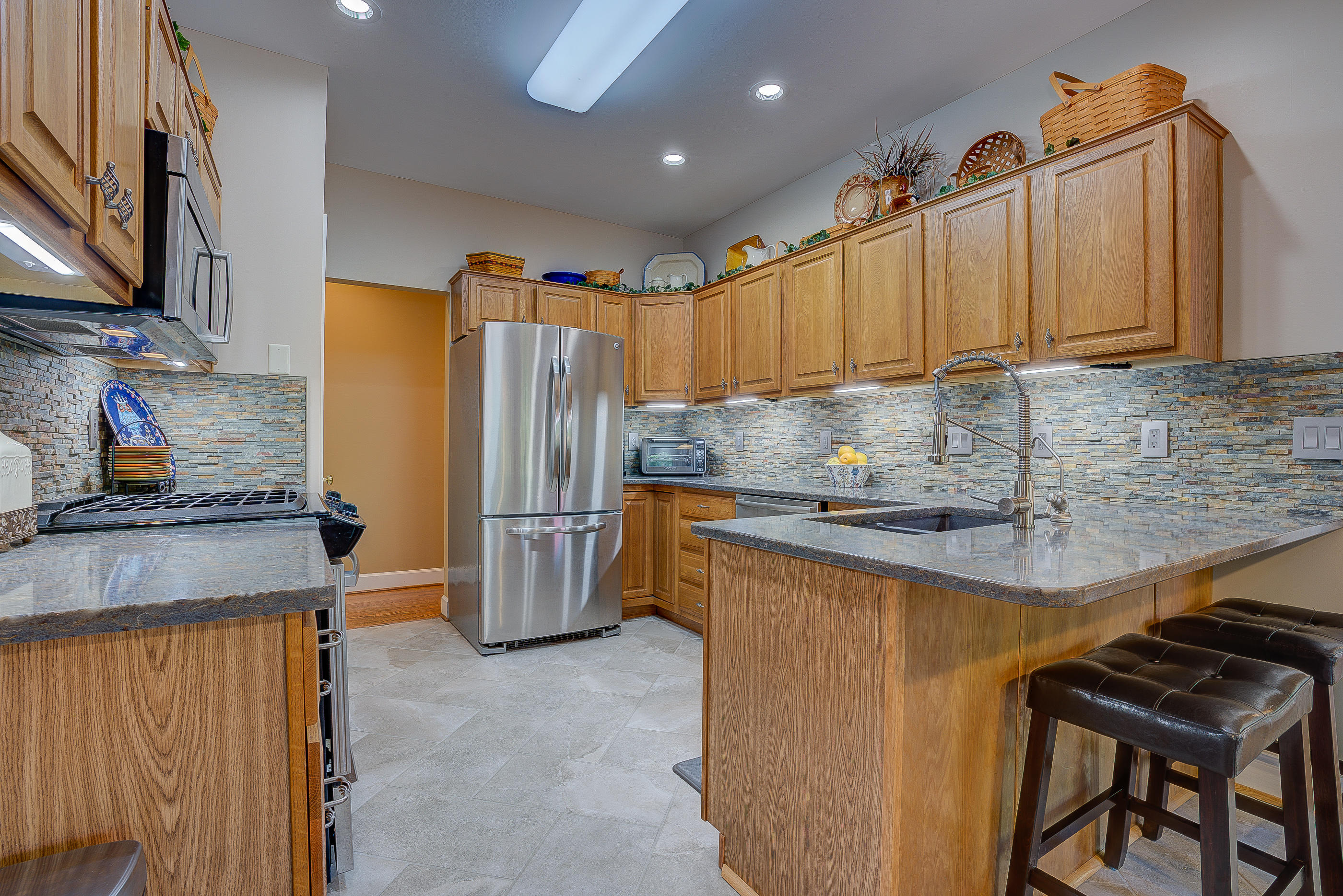 2700 New Ridge Road Elliston, VA 24087 - Photo 8 of 27 a kitchen with stainless steel appliances granite countertop a sink refrigerator and microwave