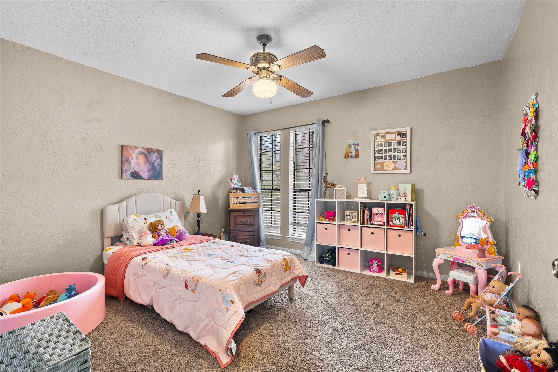 41 Windsor Drive Conroe, TX 77304 - Photo 27 of 39 Bedroom 3 featuring carpet flooring, neutral walls, ceiling fan with light fixture, and windows providing natural light.