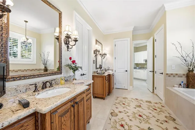 a bathroom with a tub sink and mirror