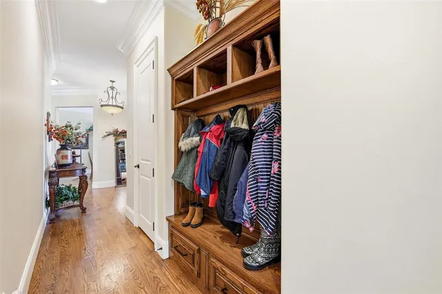 a view of a hallway with wooden floor and closet