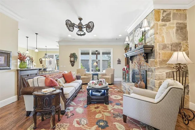 a living room with furniture a fireplace and a chandelier
